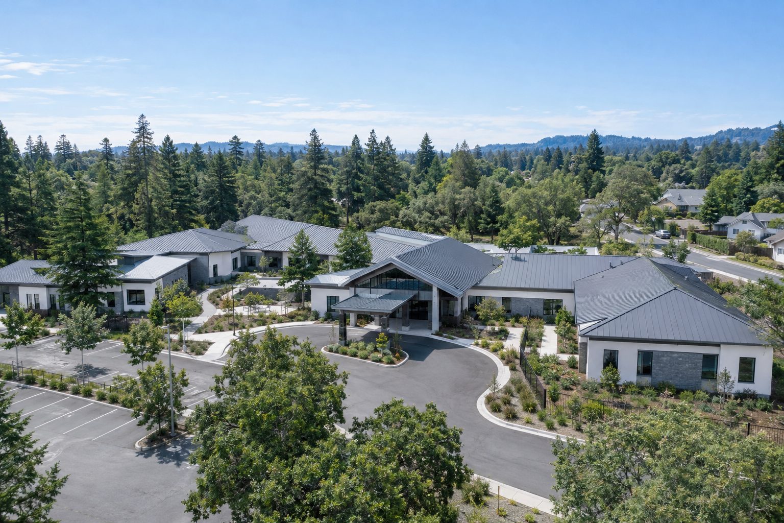 Aerial view of a single-story behavioral health treatment campus surrounded by trees